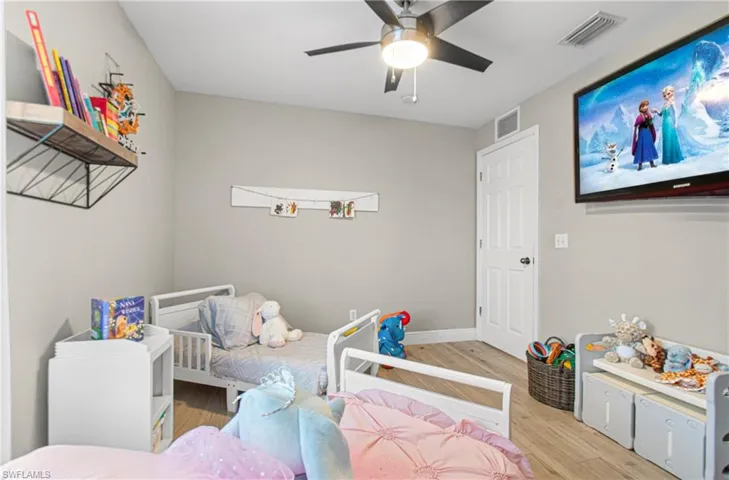 Bedroom with wood finished floors and a ceiling fan