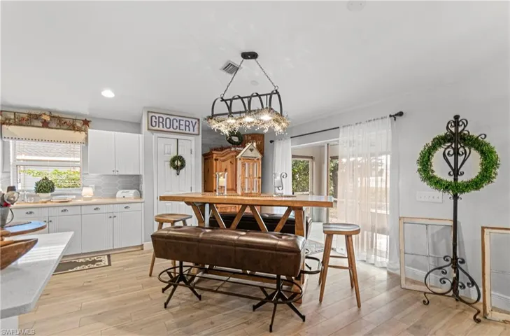 Dining space with recessed lighting and light wood-style flooring