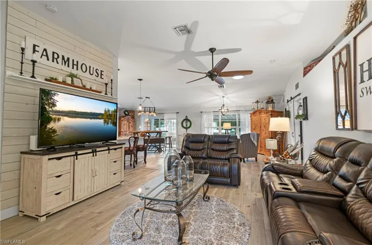 Living area featuring light wood-style flooring and a ceiling fan