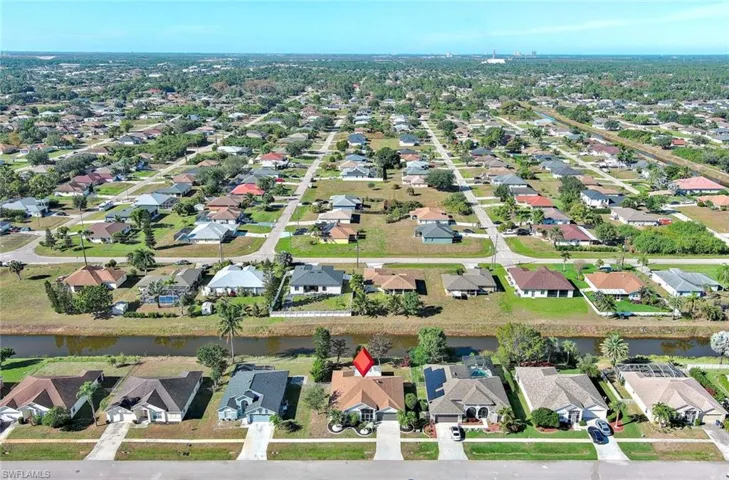 Aerial overview of property's location with nearby suburban area and a nearby body of water