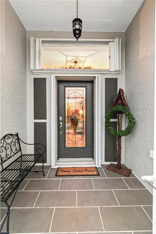 View of exterior entry featuring stucco siding