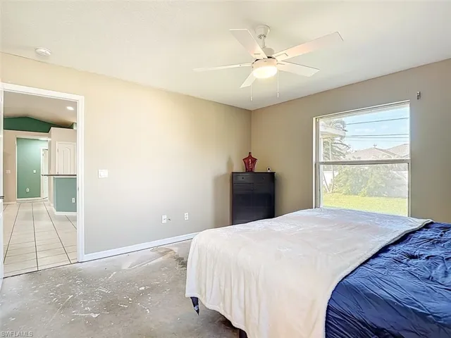 Bedroom featuring baseboards and ceiling fan