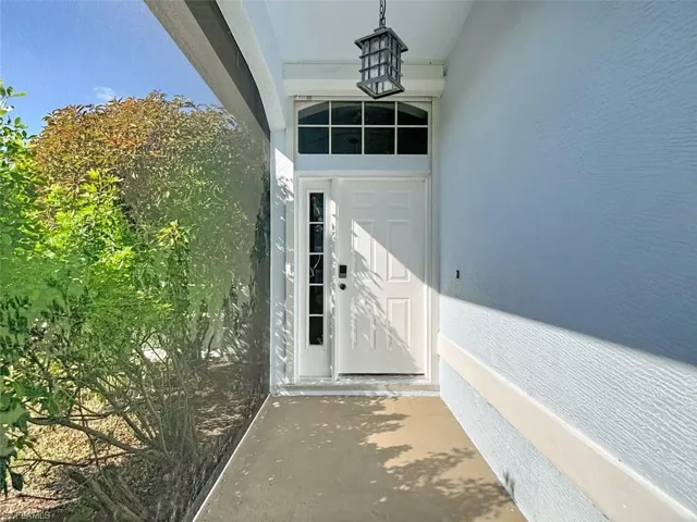 Entrance to property featuring stucco siding
