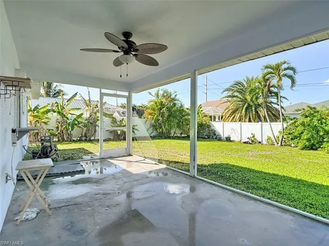 Unfurnished sunroom with ceiling fan