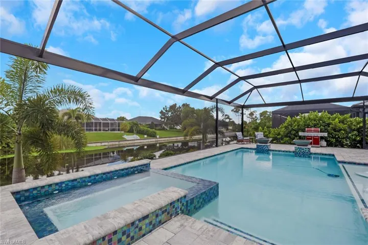 14' x 28' upgraded pool features a sun shelf with bubblers, an integrated spa/Jacuzzi, and dramatic fire bowls. The oversized paver pool deck and approximately 60' x 23' screened pool enclosure feature a picture-frame design that maximizes the relaxing waterfront views.