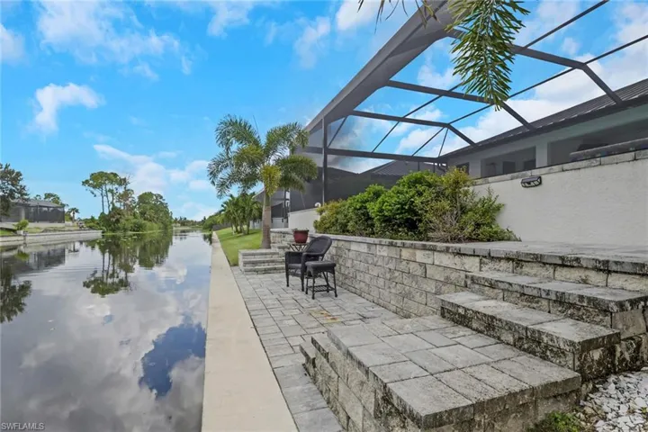 lighted paver dock leading to the water, creating another beautiful spot to enjoy the waterfront setting.