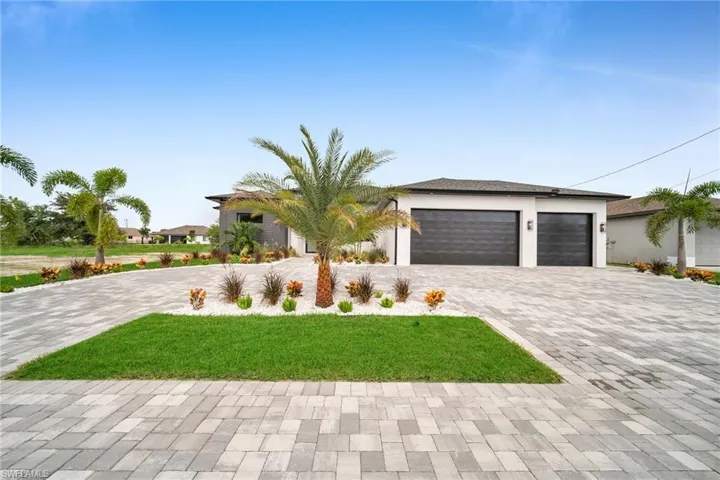 View of front of property with a garage and a front yard