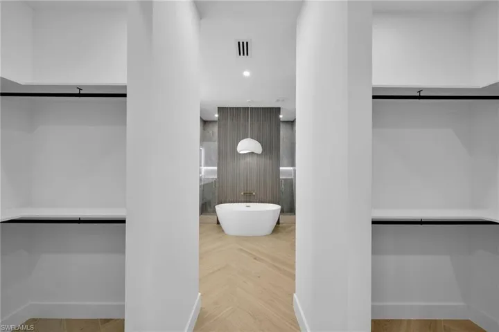 Walk in closet featuring parquet flooring