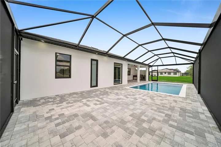 View of swimming pool with a lanai and a patio area