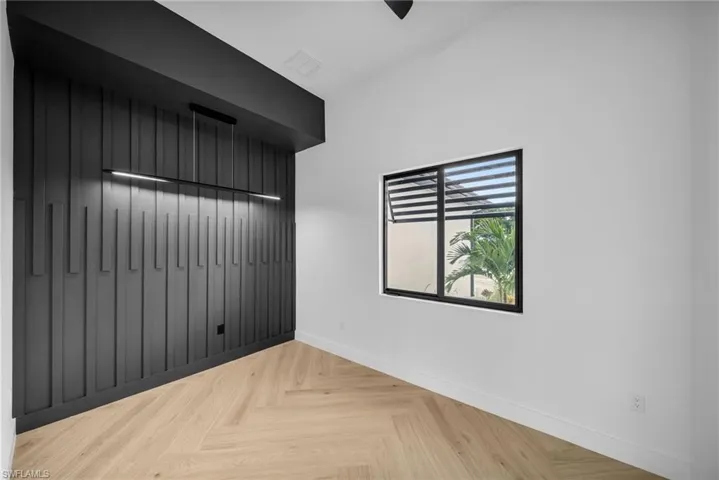 Unfurnished room with light parquet floors