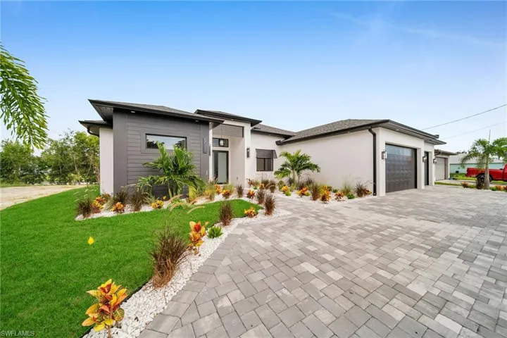View of front of house featuring a front yard and a garage