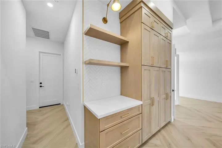 Hallway featuring light parquet floors