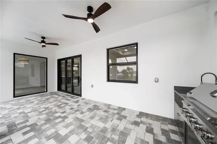 View of patio featuring ceiling fan and a grill