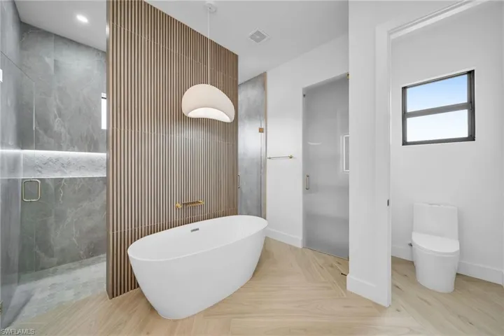 Bathroom featuring independent shower and bath and toilet