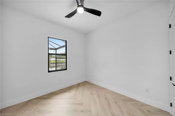 Spare room featuring light parquet flooring and ceiling fan
