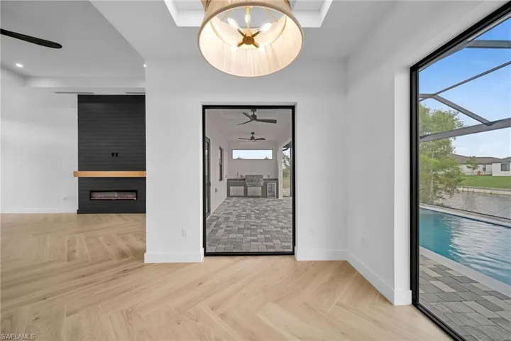 Unfurnished living room featuring a fireplace, plenty of natural light, and light parquet flooring