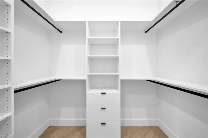 Spacious closet featuring light hardwood / wood-style floors