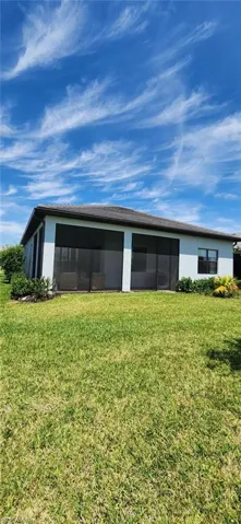 View of outbuilding featuring a sunroom