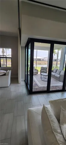 Living room featuring a healthy amount of sunlight and baseboards