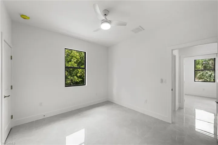 Unfurnished bedroom with ceiling fan and baseboards