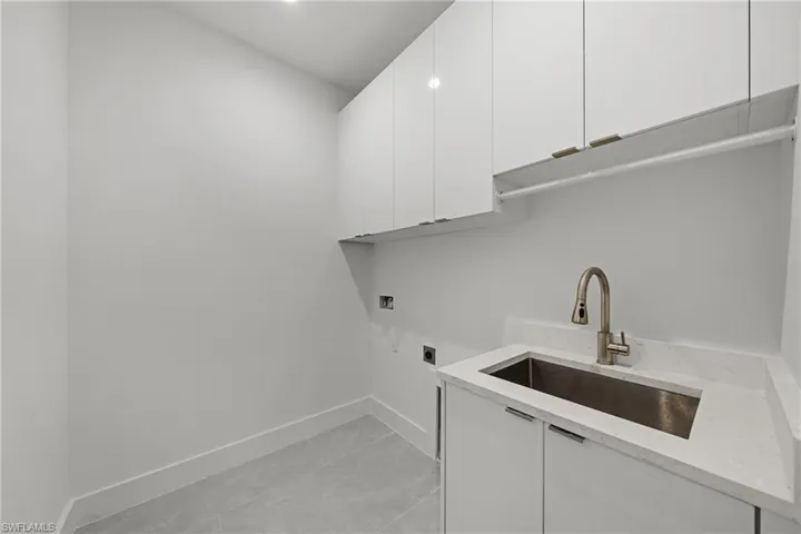 Laundry room featuring cabinet space, hookup for an electric dryer, and hookup for a washing machine