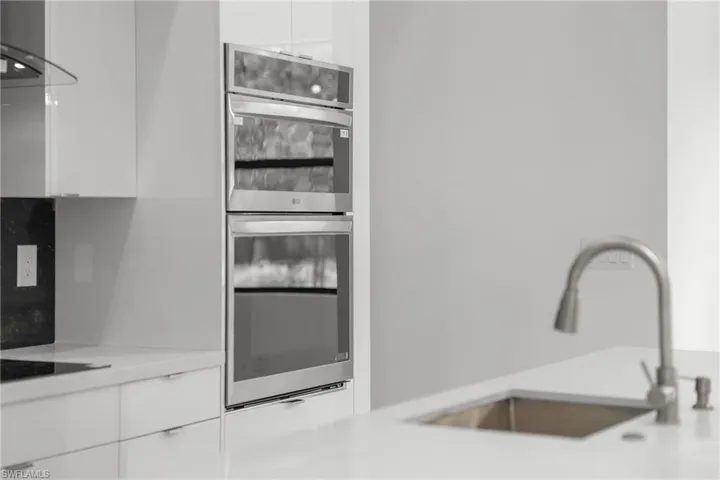 Kitchen featuring wall mounted double oven-microwave