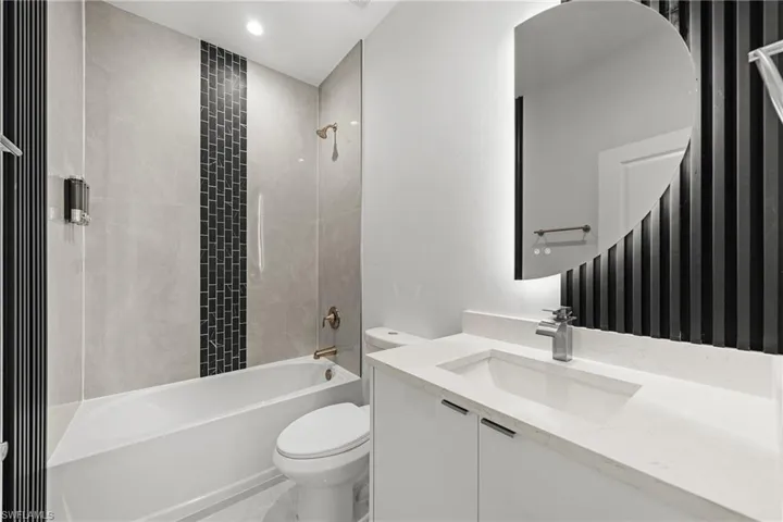 Full bath featuring vanity, tub / shower combination, and recessed lighting