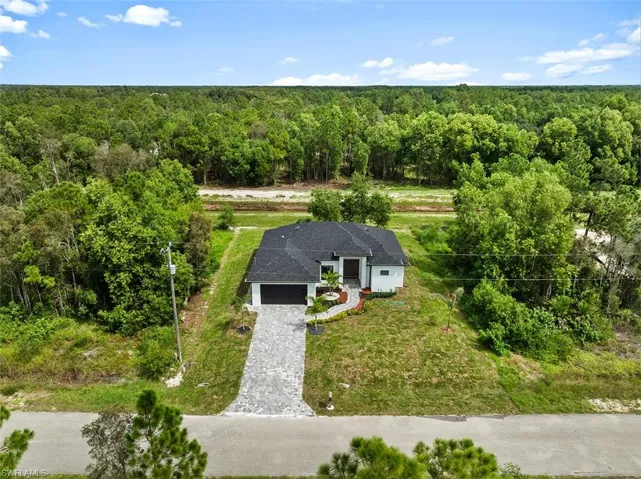 View from above of property with a forest