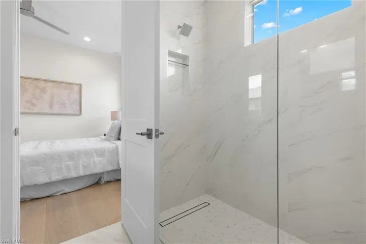 Bathroom featuring a tile shower and hardwood / wood-style flooring