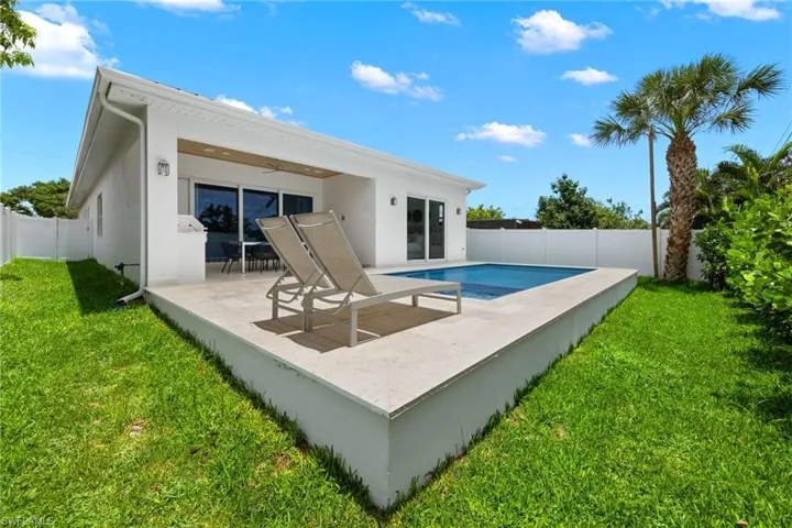 View of swimming pool with a patio and a yard