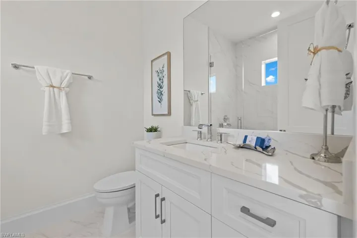 Bathroom with tile flooring, vanity, and toilet