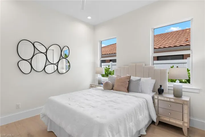 Bedroom featuring multiple windows and light hardwood / wood-style flooring