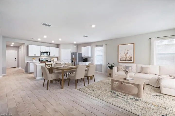 Living room with light hardwood / wood-style flooring and plenty of natural light