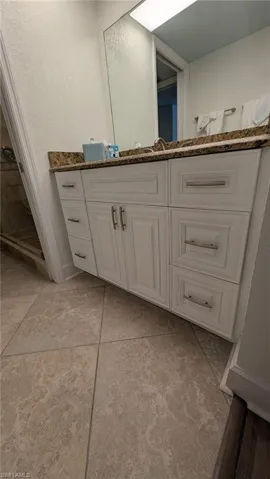 Bathroom featuring tile patterned floors and vanity