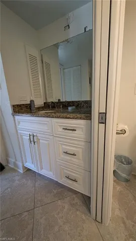 Bathroom with tile patterned flooring, vanity, and baseboards
