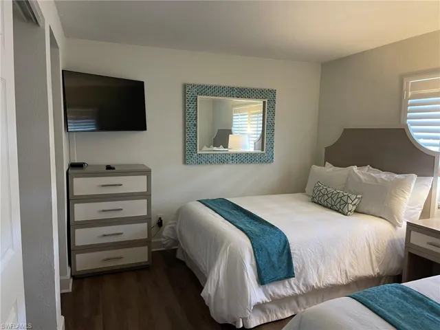 Bedroom with dark wood-style floors