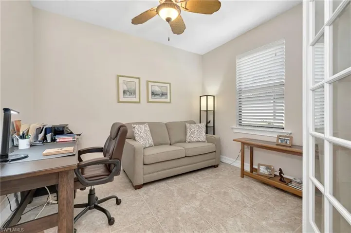 Tiled office featuring ceiling fan
