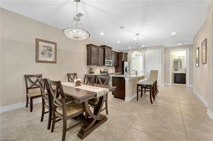 Tiled dining room with sink