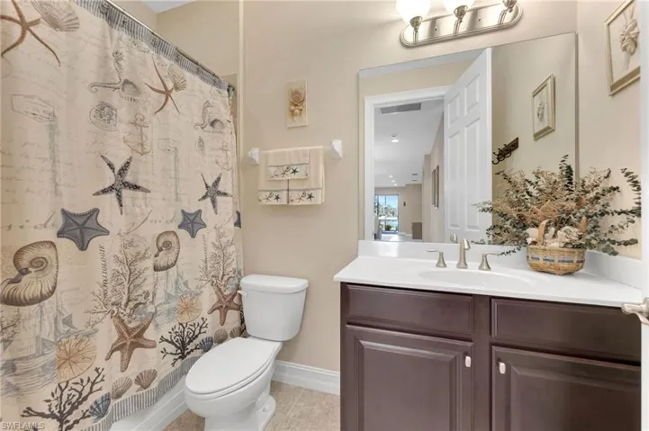2nd Bathroom featuring tile patterned floors, a shower with shower curtain, vanity, and toilet