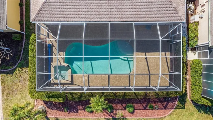 View of pool with a patio area, an in ground hot tub, and glass enclosure