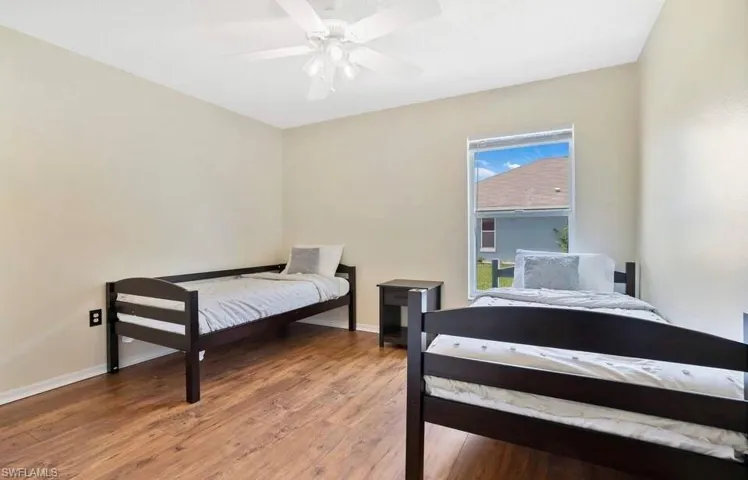 Bedroom with wood finished floors and ceiling fan