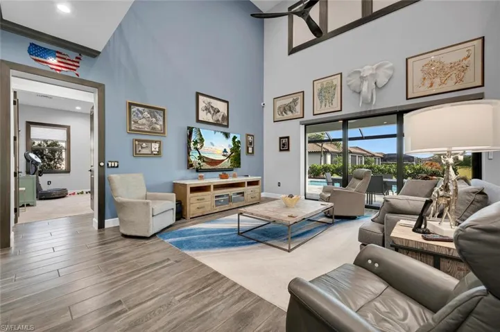 Living room featuring a healthy amount of sunlight and a high ceiling