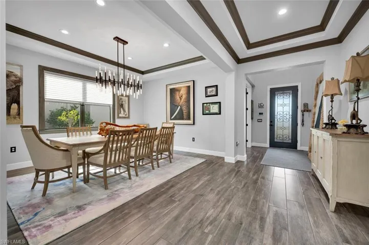 Dining space featuring crown molding and a notable chandelier