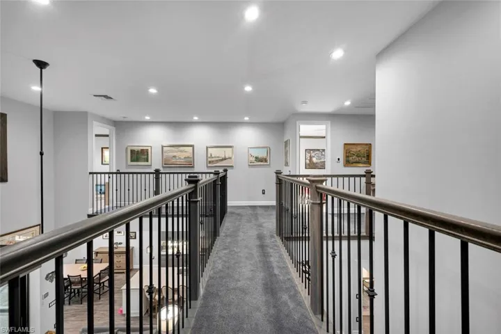 Hallway with dark colored carpet
