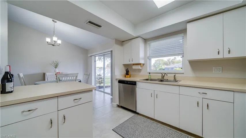 Lots of countertops in the brightly lit kitchen.