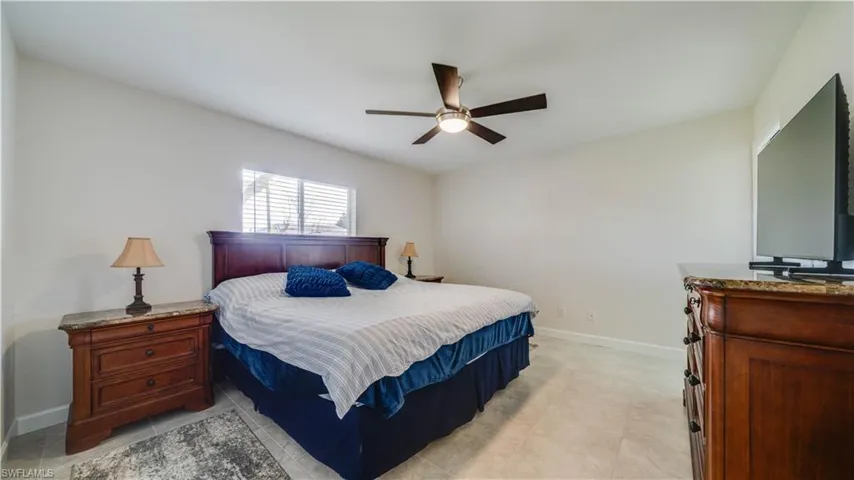Primary Bedroom with  tile floors and modern fan.