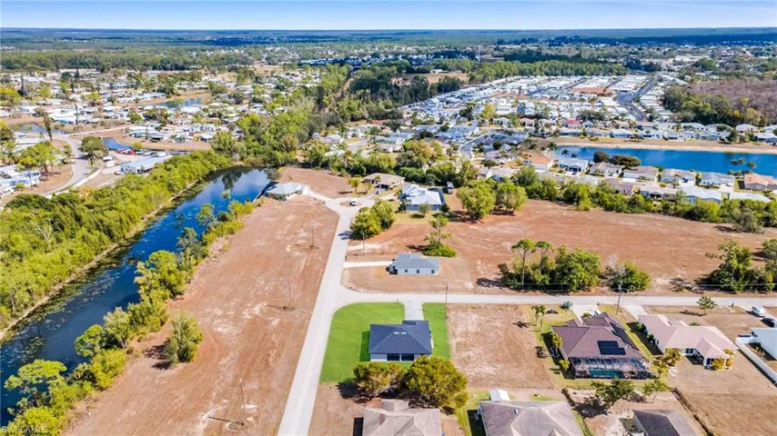 Aerial view of residential area featuring a nearby body of water