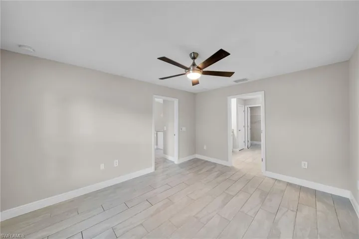 Spare room with ceiling fan and wood finish floors