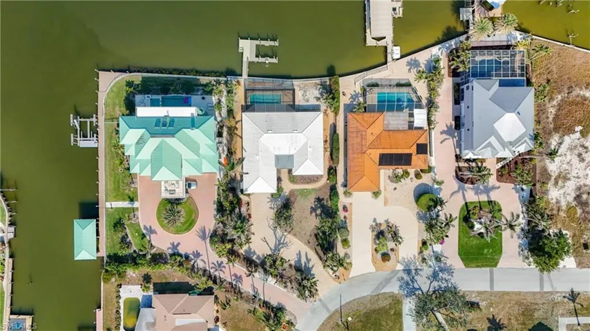 Drone / aerial view.  Home with white roof