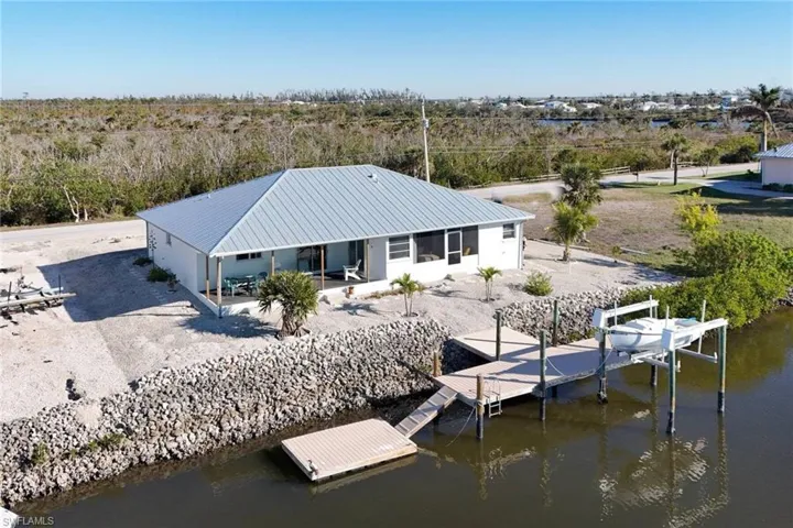 Rear view of house with a water view and a metal roof